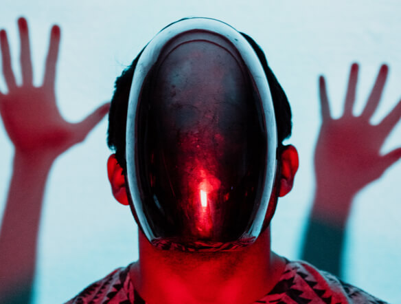 A person in a glowing red mask